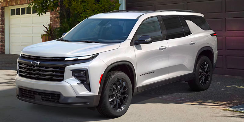 A whited 2025 Chevy traverse parked in a driveway.