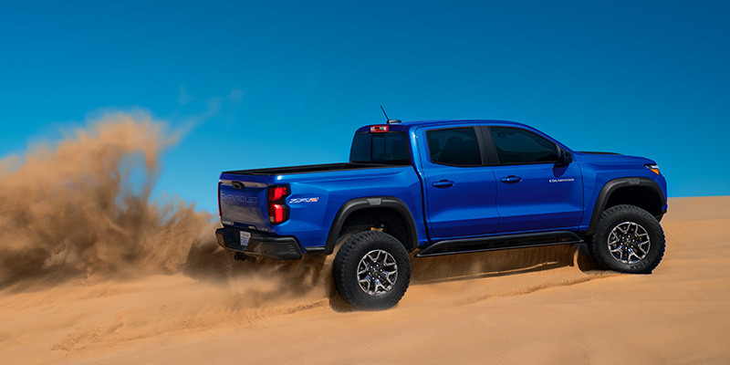 a blue 2025 Chevrolet Balzer driving on a sand dune
